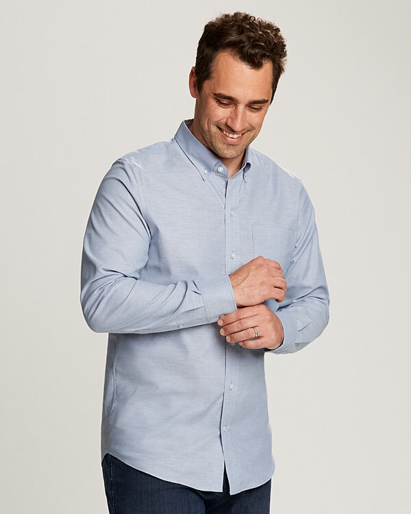 Man wearing Cutter & Buck Men’s Tailored Fit Stretch Oxford in French Blue