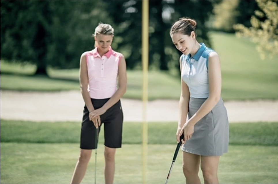 Woman playing golf in cutter and buck gear