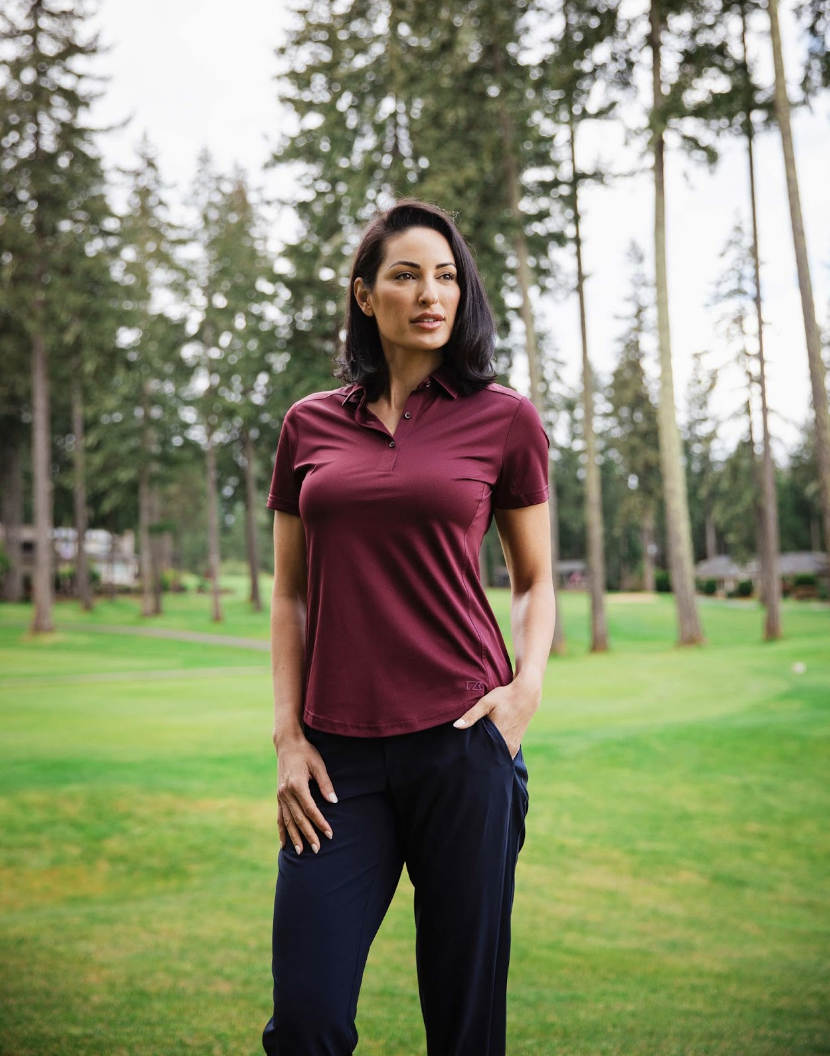 Woman on golf course wearing a Cutter & Buck Prospect Textured Stretch Womens Short Sleeve Polo