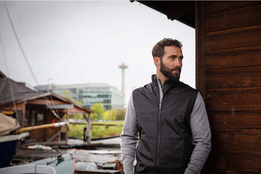 Man on dock wearing Cutter & Buck Stealth Hybrid Quilted Mens Full Zip Windbreaker Jacket