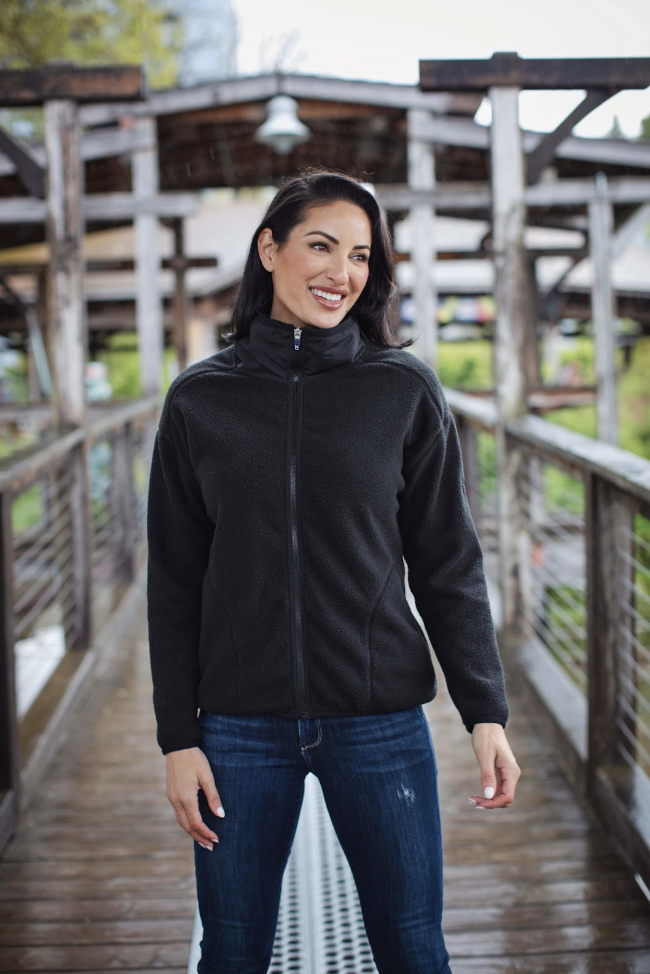 Woman outside on bridge wearing Cutter and Buck sherpa fleece