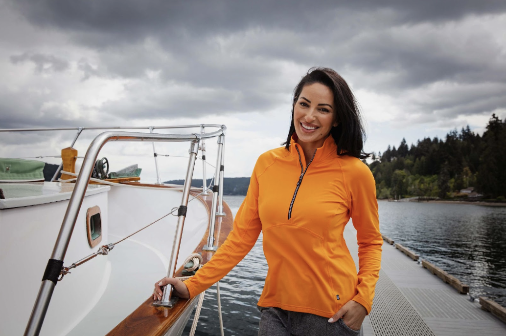 Woman on boat wearing a Cutter and Buck women's pullover