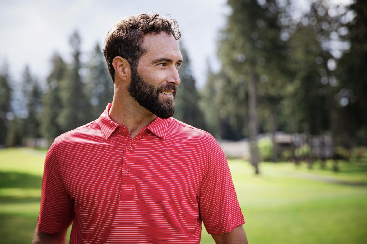 man on golf course wearing a cutter and buck golf polo