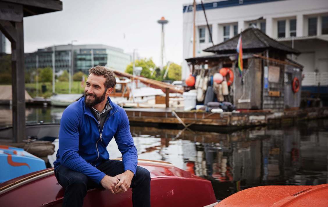 man sitting on boat wearing lightweight jacket