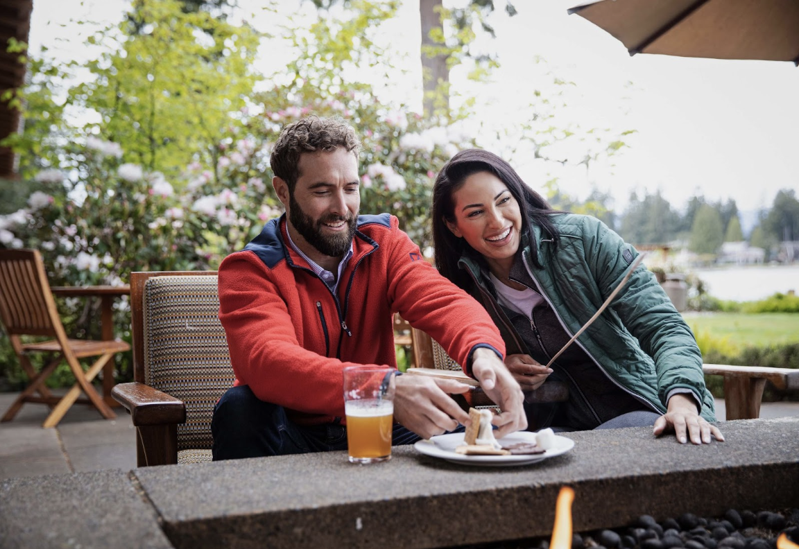 Man making smores with friend wearing sherpa jacket