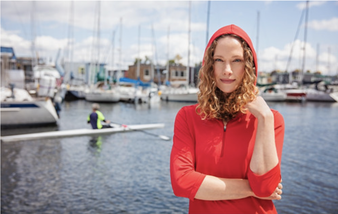 woman at boat dock wearing pullover