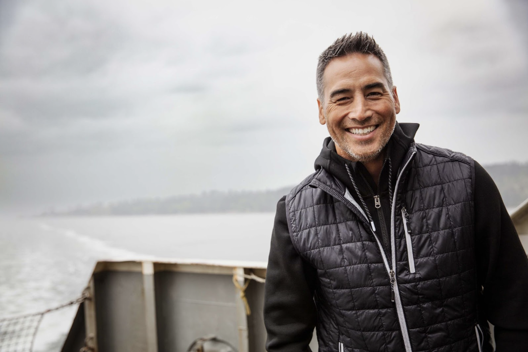 man on boat wearing puffer vest