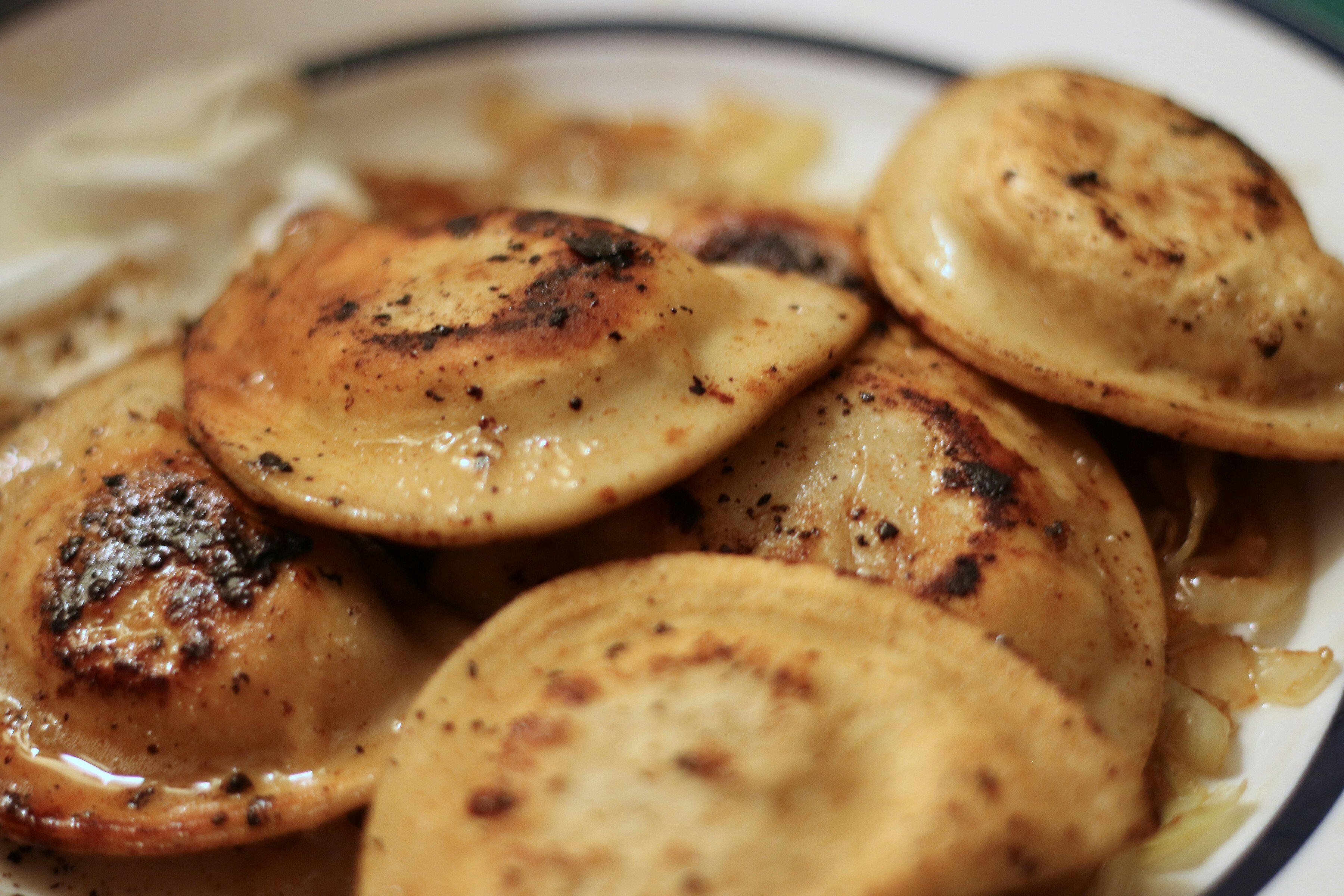 a white plate topped with pierogi