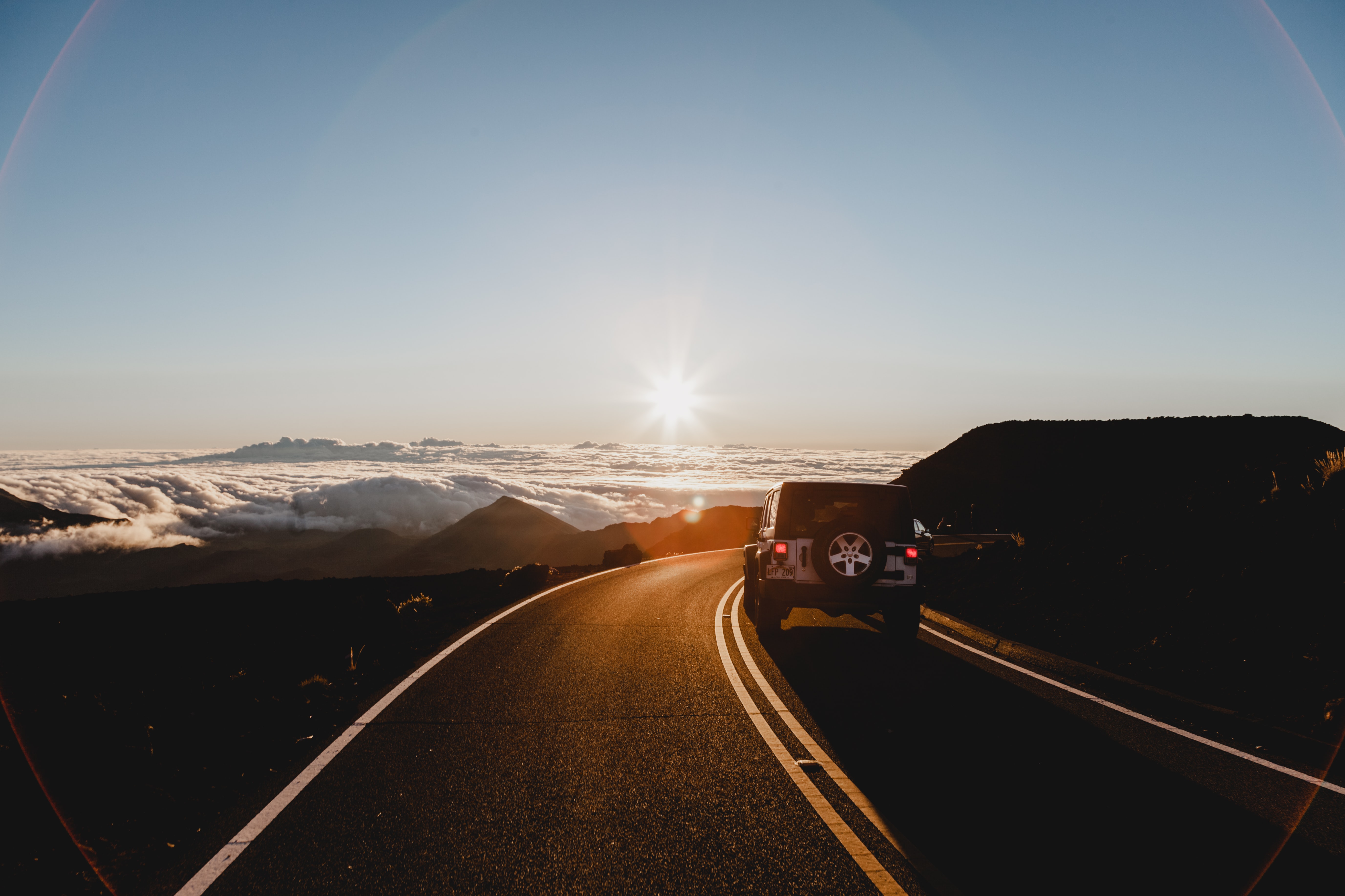 car driving on a road trip through the mountains