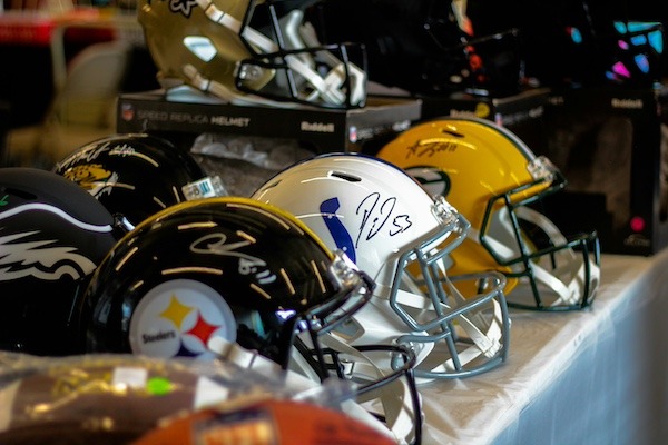 Packers, Colts, Steelers, Eagles and Jaguars NFL helmets on display