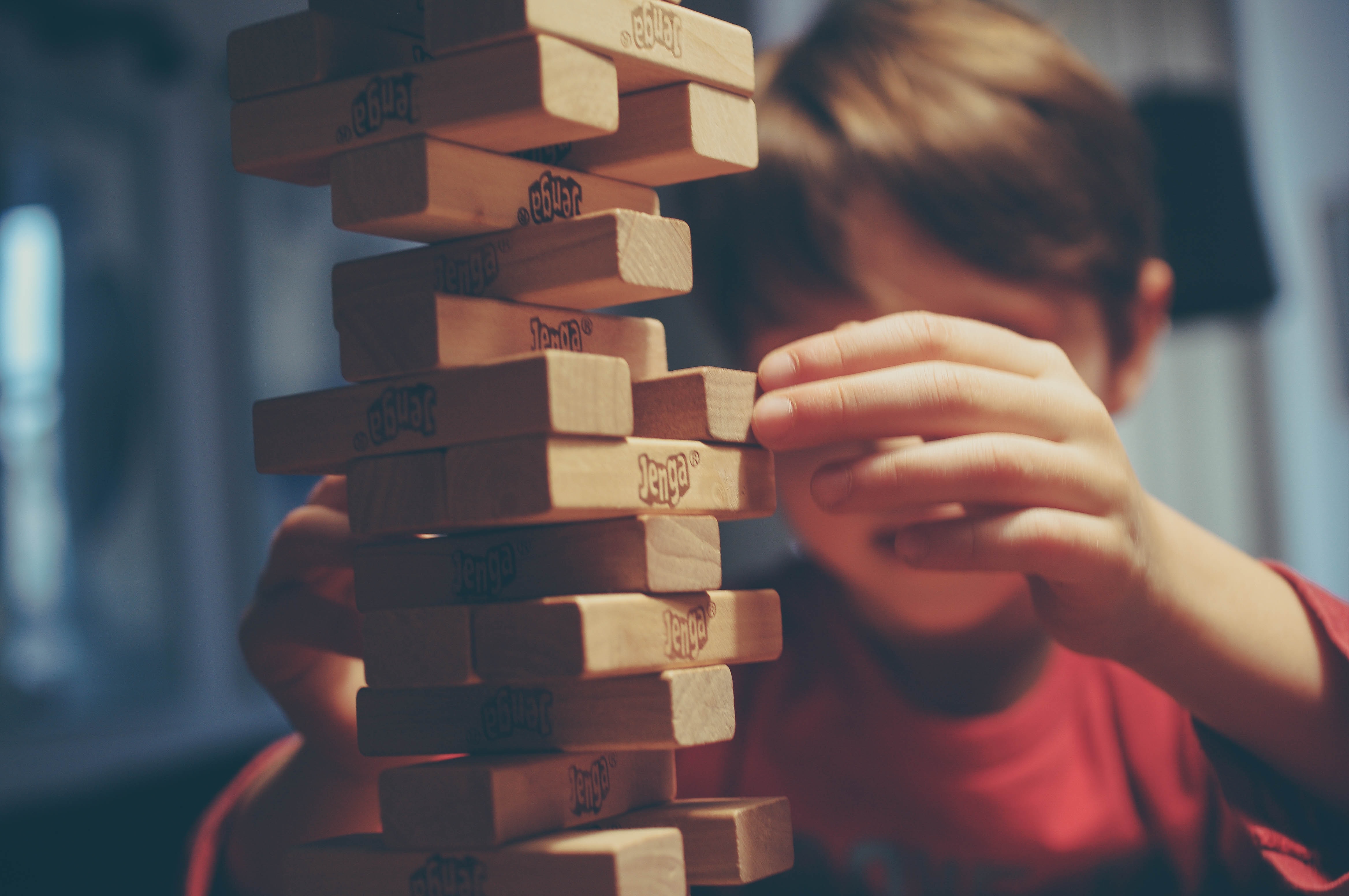 kid playing board game with family