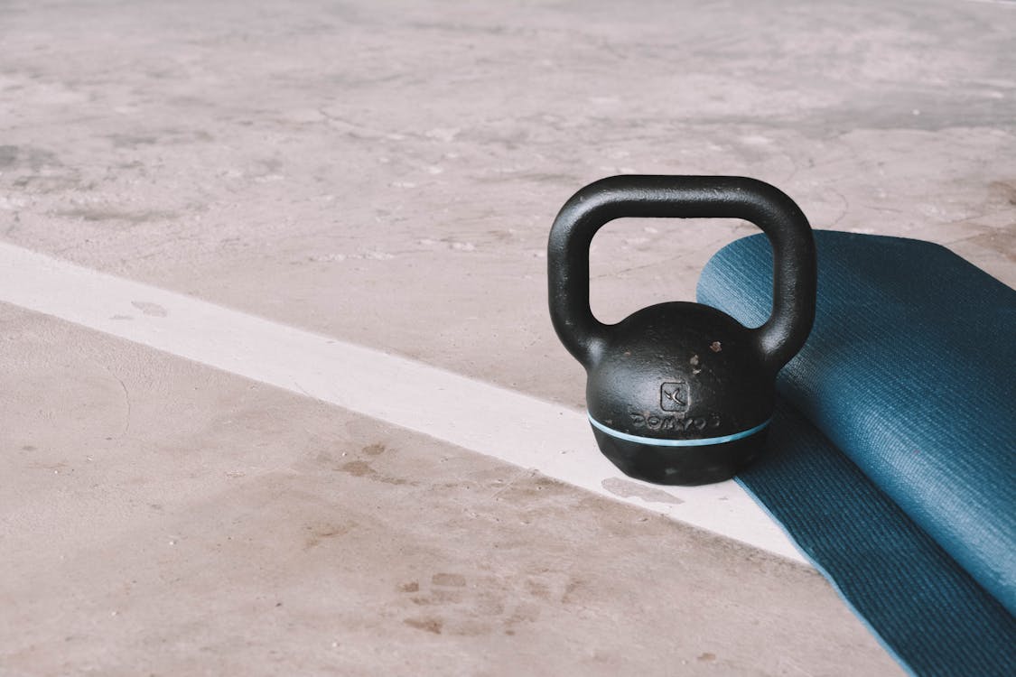 A kettlebell and a yoga mat